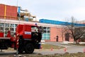 Firemen rescue workers in fireproof suits came to extinguish a fire in a fire truck and stretch the hoses in a large industrial Royalty Free Stock Photo