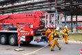 Firemen rescue workers in fireproof suits came to extinguish a fire in a fire truck and stretch the hoses in a large industrial Royalty Free Stock Photo