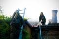 Firemen In a special form on the roof of a burning house