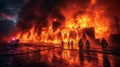 Firemen Standing in Front of Huge Fire Royalty Free Stock Photo