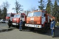 Firemen standing near fire trucks before training