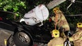 Firemen use jaws of life to extricate car crash victims