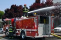 Firemen using water canon on fire truck to put out apartment fire Royalty Free Stock Photo