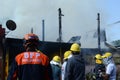 Firemen and volunteers working extinguishing fire on a subdivision house Royalty Free Stock Photo