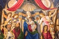 Renaissance religious painting showing Virgin Mary holding baby Jesus while surrounded by saints and angels