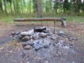 A firepit with a rustic wooden bench