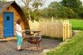 Woman cooking scrambled egg, via a firepit whilst glamping, in Cumbria. Royalty Free Stock Photo