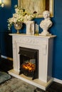 Fireplace area with artificial flowers