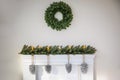 Fireplace with beautiful Christmas wreath, decorations in room Royalty Free Stock Photo