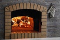 Fireplace with burning fire. Brick wall Royalty Free Stock Photo