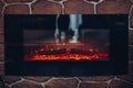 Fireplace with burning logs. Close-up of stony fireplace with burning or smoldering logs on fire. Royalty Free Stock Photo