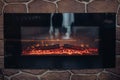 Fireplace with burning logs. Close-up of stony fireplace with burning or smoldering logs on fire. Royalty Free Stock Photo