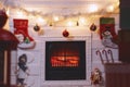 Fireplace with Christmas boxes. Fireplace decorated for Christmas with glowing fire and toys. New year concept design. Selective Royalty Free Stock Photo