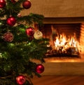 Christmas tree close up on burning fireplace background Royalty Free Stock Photo