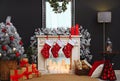 Fireplace with Christmas stockings in room interior Royalty Free Stock Photo