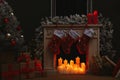 Fireplace with Christmas stockings in room interior Royalty Free Stock Photo