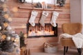 Fireplace with Christmas stockings. Festive interior