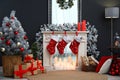 Fireplace with Christmas stockings in room interior Royalty Free Stock Photo