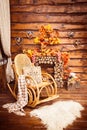 Fireplace collected from logs, rocking-chair and furs in the room Royalty Free Stock Photo
