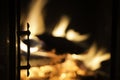 Fireplace door in silhouette with blazing fire in background Royalty Free Stock Photo