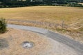 fireplace in dry grass next to a dirt road