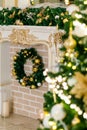 Fireplace with a fir wreath, Christmas toys, balls and garlands on a spruce branch on christmas tree Royalty Free Stock Photo