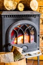 Fireplace with fire flame and firewood in barrel interior. Heating. Royalty Free Stock Photo