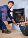 Fireplace, fire and portrait of man in home for heat, warmth and light in winter with wood. Flame, burning and person Royalty Free Stock Photo