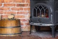 Fireplace and firewood in barrel. Heating. Royalty Free Stock Photo