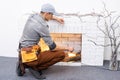 Fireplace installing in white brick wall. Royalty Free Stock Photo