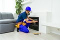 Fireplace installing in white brick wall. Royalty Free Stock Photo