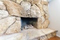 Fireplace interior with large stones surround and hearth Royalty Free Stock Photo