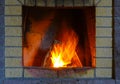 Fireplace made of silicate bricks. A fire is burning in the fireplace