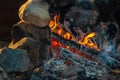 Fireplace made of stones with hot, glowing logs Royalty Free Stock Photo