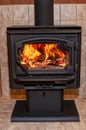 Fireplace with a roaring fire inside Royalty Free Stock Photo