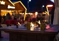 Fireplace at traditional christmas market Christkindlmarkt at Meran Merano, South Tyrol Italy