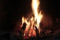 A fireplace flames together with timbers