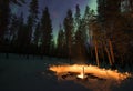 Fireplace in the forest with aurora borealis above. Royalty Free Stock Photo