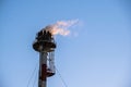 Firer on the top of the tower of the petrochemical industry in a refinery in Tarragona, Spain