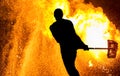 Fireshow performance. Silhouette of man with hammer Royalty Free Stock Photo
