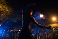 Firestarter performs a stunning fire show at night on the street. Royalty Free Stock Photo