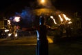 Firestarter performs a stunning fire show at night on the street. Royalty Free Stock Photo