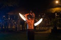 Firestarter performs a stunning fire show at night on the street. Royalty Free Stock Photo
