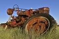 Old M Farmall tractor missing rear wheels