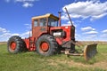 Versatile tractor with a blade