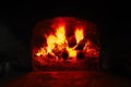 Firewood burning in brick oven, fire flame closeup