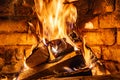 Firewood burning in fire burns in the fireplace. The brick oven gives heat and heat from the burnt logs. Burning coals and flames Royalty Free Stock Photo