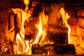 Firewood burning in fire burns in the fireplace. The brick oven gives heat and heat from the burnt logs. Burning coals and flames Royalty Free Stock Photo