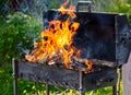 Firewood burns in a metal grill