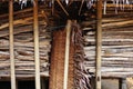 Firewood and coconut fiber roofing are stored next to the Baduy traditional house